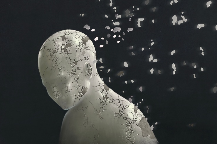 A pale human figure breaking into fragments against a dark background